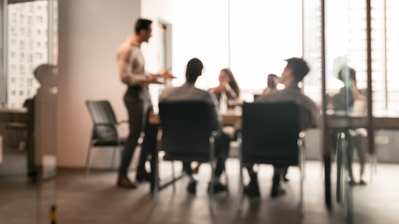 Colleagues having meeting in boardroom