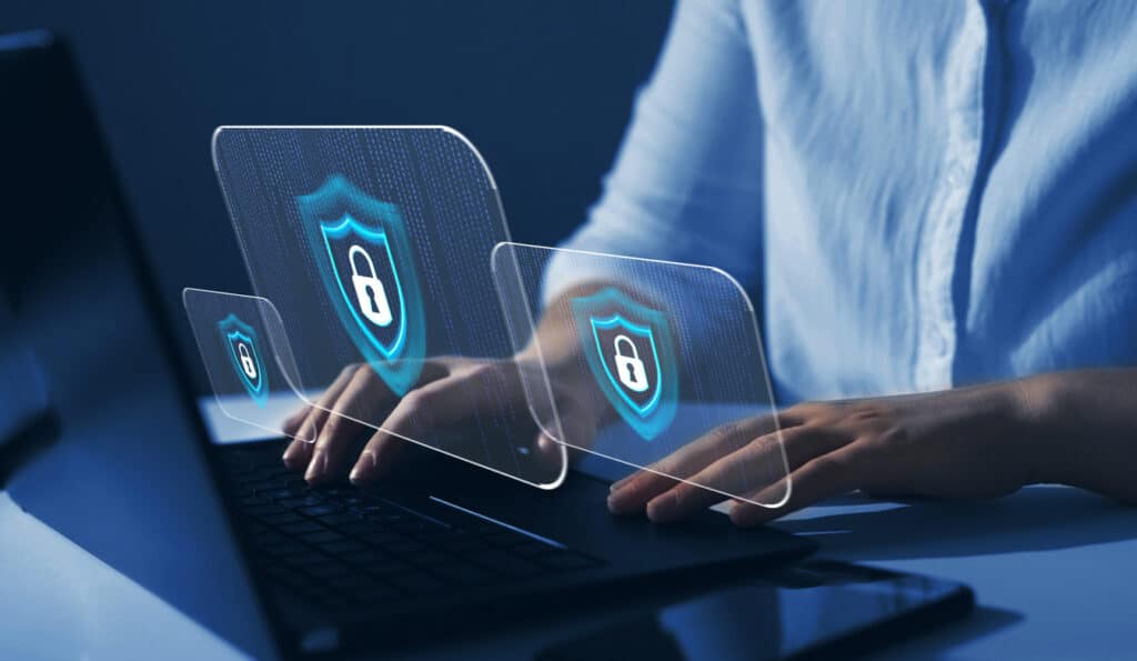 Cyber security firewall interface protection graphic floating above a laptop as a woman types
