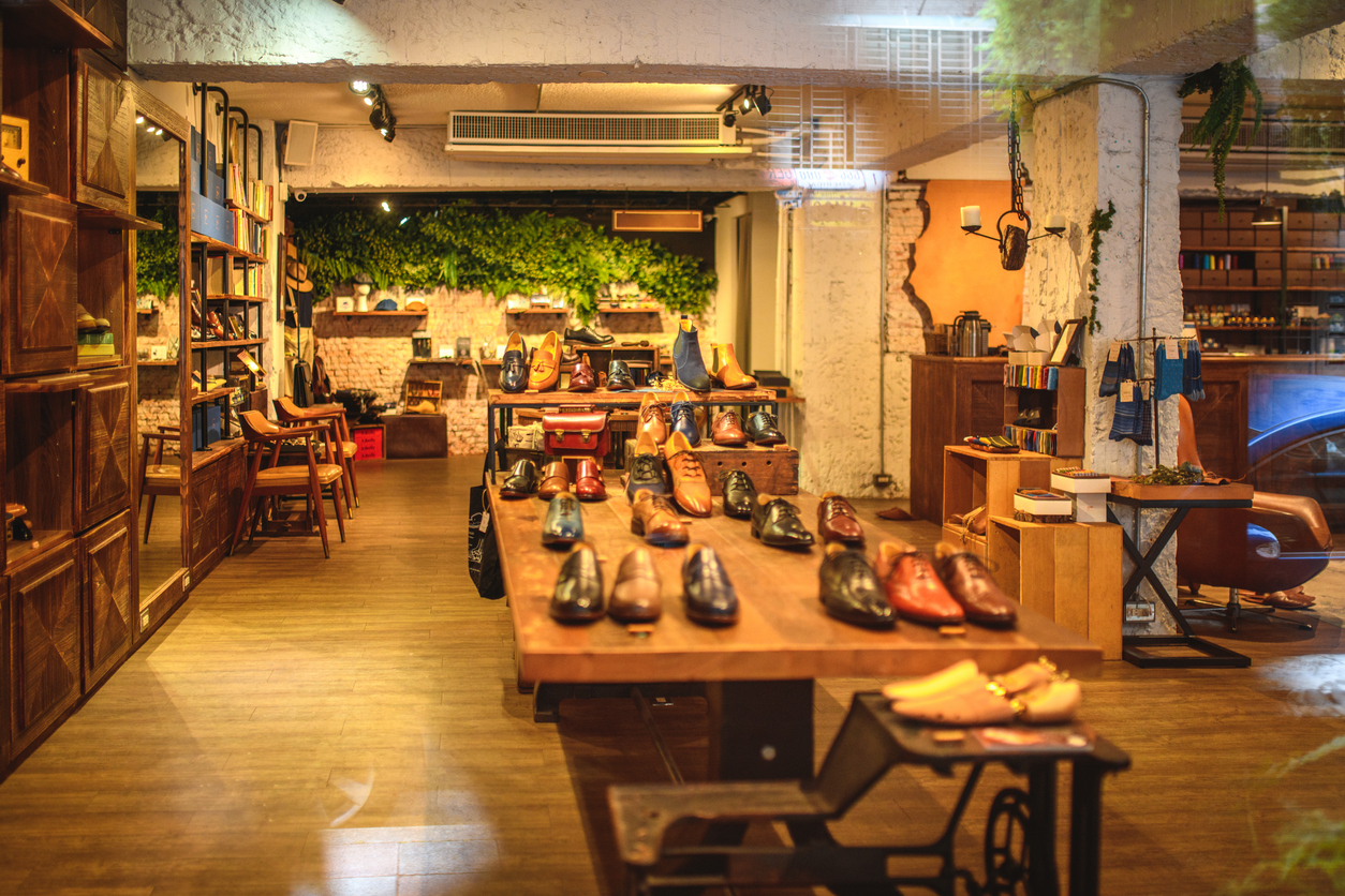 Display of a cozy shoe shop. Photographed through window.
