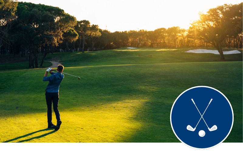Man swings golf club at golf course